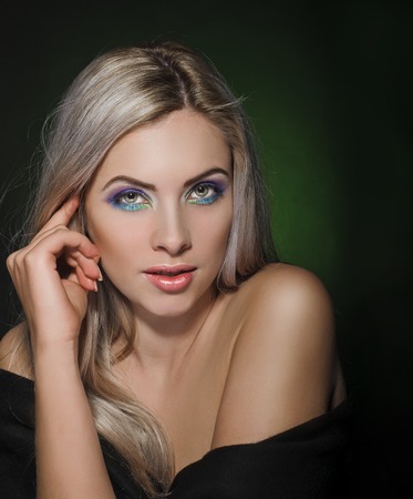 Blond Hair. Beautiful Sexy Blonde Girl. dark and green backgroundの写真素材