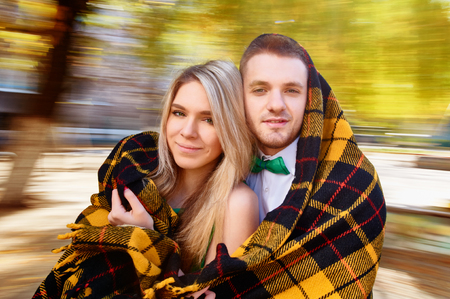 couple having fun on spinning roundabout. Autumn. Naturally blur motionの写真素材