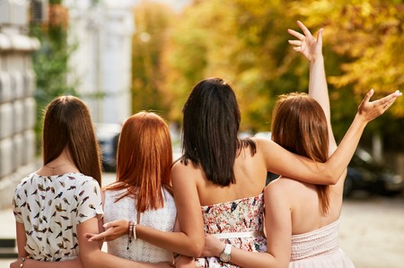 summer autumn vacation, holidays, travel and people concept - group of young women on city street...