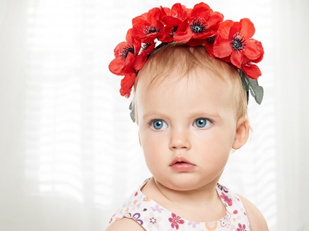Cute smiling baby close at home in white room near windowの写真素材