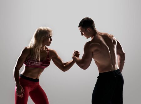 Man and woman are against each other in a bit darkの写真素材