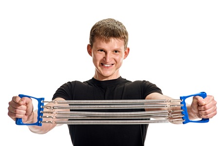 fitness, sport, exercising, training and lifestyle concept - young man portrait with expander on white backgroundの写真素材