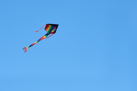 colorful kite flying high in the sky blue