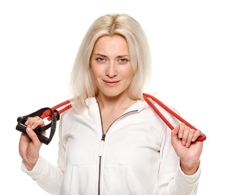 athletic woman exercising with rubber tape on white background. studio
