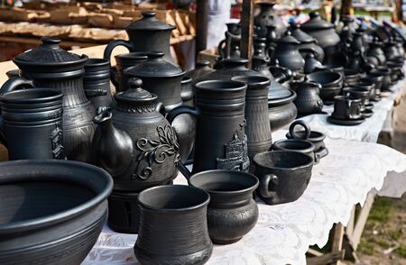 Many earthen pots on market table. Ukraine, Carpathiansの写真素材