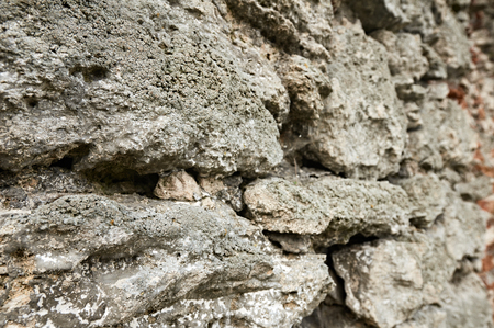 pattern gray color of old style design stone wall surface with cement. focus is on foregroundの写真素材