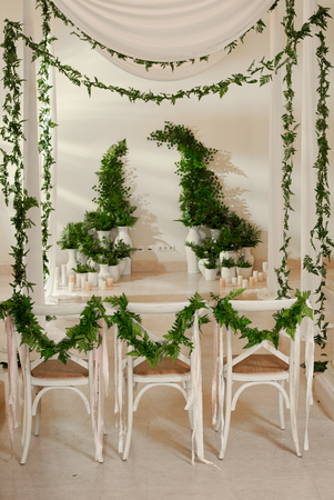 white three wedding chairs and decorations indoor for weddingの写真素材