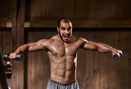 Sportsman lifting dumbbellsの写真素材