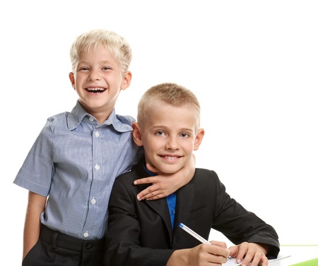 Schoolboy embracing brotherの写真素材