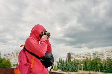 Young photographer in city