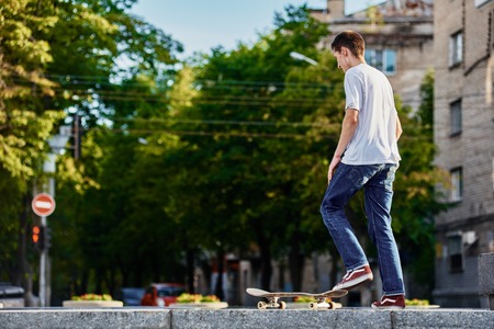 Skillful skateboarder before jumping with his board on urban street. Ukraine, Dnepr- July 08, 2017のeditorial素材