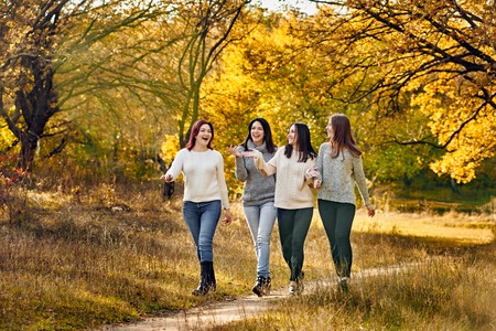 Girlfriends in the autumn parkの写真素材