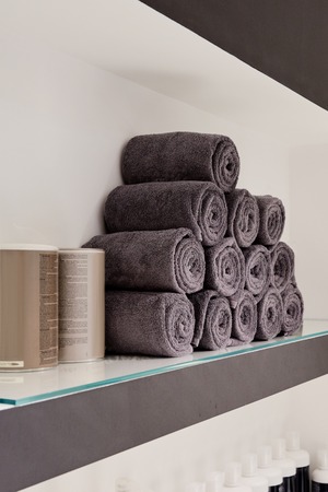 Closeup of shelf with cotton towels in modern hairdressing salonの写真素材
