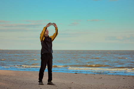 Man on the beach photographing