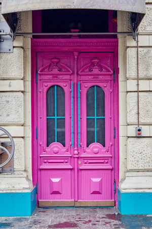 Closeup of old pink wooden house entrance doorの写真素材