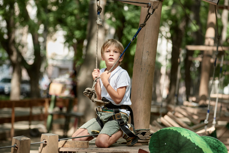 Exhausted boy climbingの写真素材