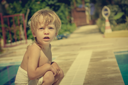 Boy sitting near poolの写真素材