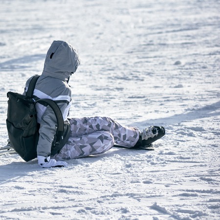 Skier falling on snowの写真素材