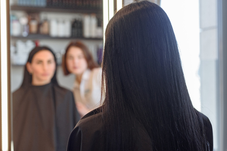 Barber showing hairstyleの写真素材