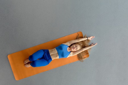Sportswoman on yoga mat