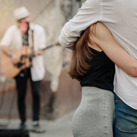 Couple listening buskerの写真素材