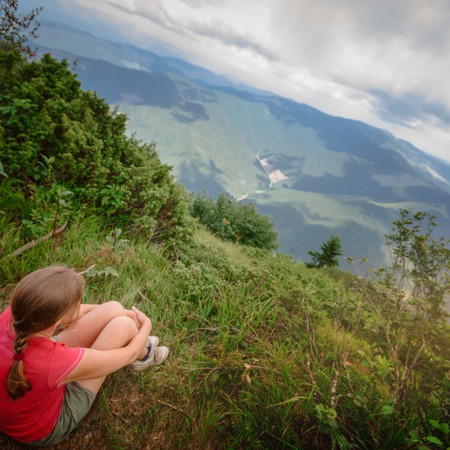 Woman sitting on hillの写真素材