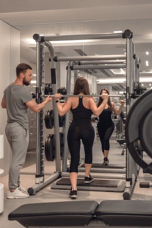 Female weightlifter with instructorの写真素材