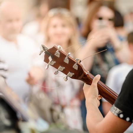 Busker playing on guitar