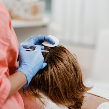 Cosmetologist doing injectionの写真素材