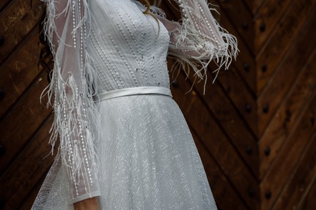 Closeup of woman posing in fashionable white wedding dressの写真素材