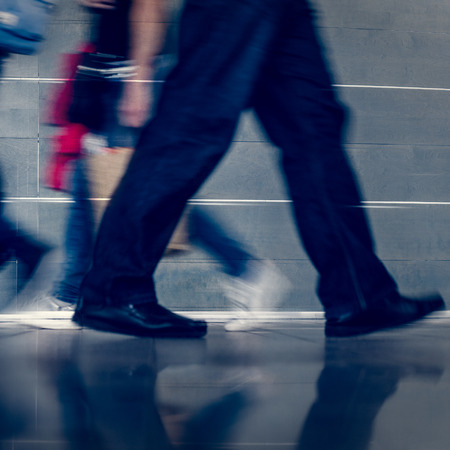 Closeup photo of businessman in black suit going to workの写真素材