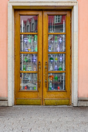photo of wooden entrance door in facade of buildingの写真素材