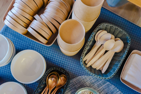 Top view of empty plate and spoon on table in cafeの写真素材