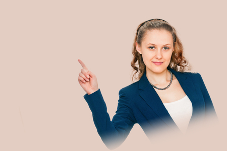 young woman pointing finger. isolated on background salmon shade red. point towardsの写真素材