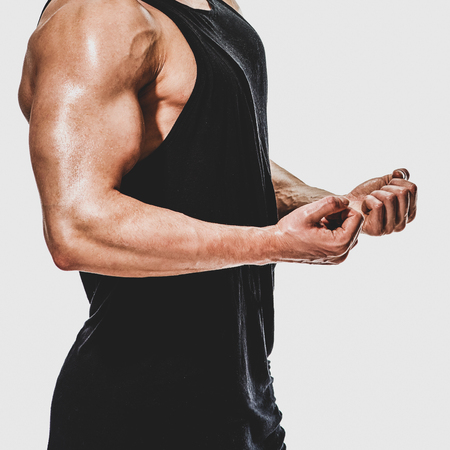 Side view photo of young muscular bodybuilder trainingの写真素材