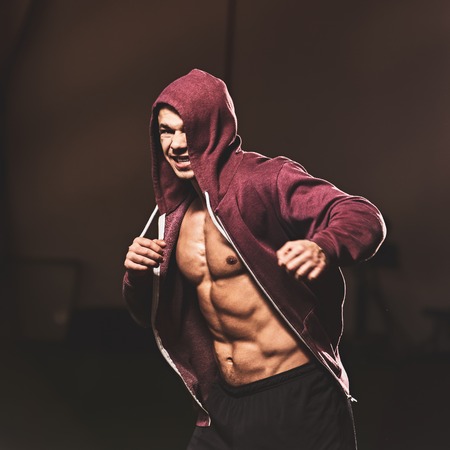 Strong muscular fighter training hard in modern gymの写真素材