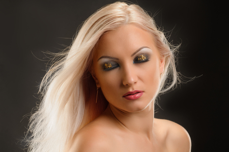 Beautiful woman with straight hair and bright evening makeupの写真素材