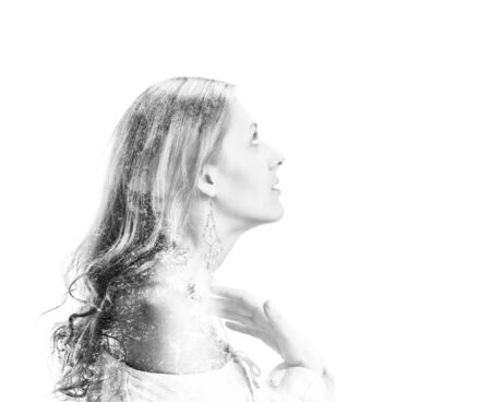 Portrait of a beautiful female model with long hair and naked shoulder on white background. double multiple exposure effectの写真素材