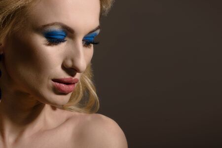 Beautiful blonde with luxury jewelry and closed eyes