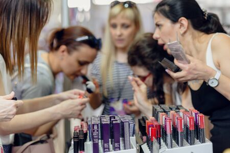 Dnepr, Ukraine- Maj 18, 2019: Closeup of woman choosing decorative cosmetics at the beauty storeのeditorial素材