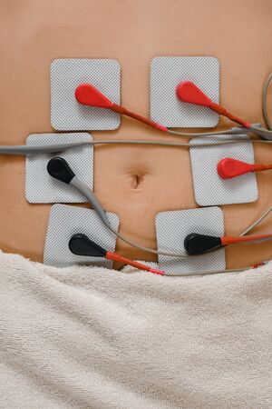 Professional procedure of myostimulation on female belly in beauty salonの写真素材