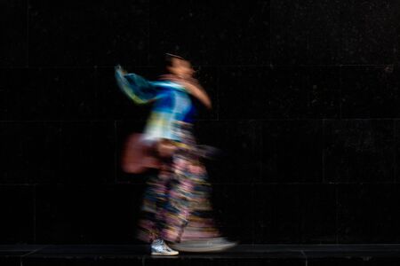 Carefree happy musician posing with guitar. Long exposure, intentional camera shake to introduce an impressionistic effectの写真素材