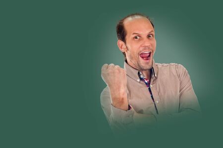young man showing negative sign on background pine shade green