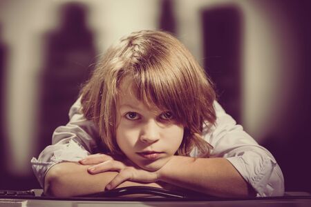 Portrait of cute young boy dreaming. Retro or vintage styleの写真素材