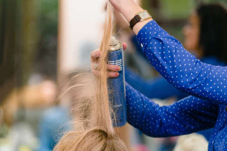 Dnepr, Ukraine- September 11, 2018: hairdresser using spray. Open workshop master class of hairdressing Maya Norkinaのeditorial素材