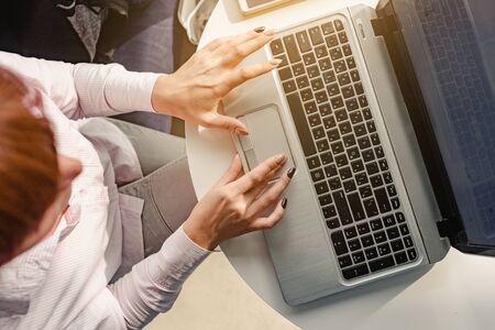 Top view photo of young businesswoman working on laptop