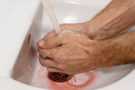 Closeup of man washing dirty hands with virus covid-19の写真素材
