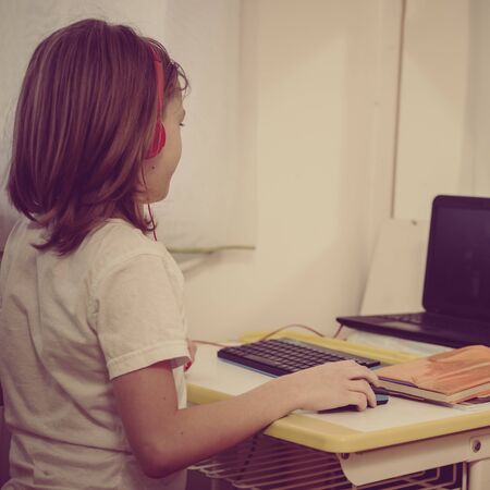 Young boy having video chat with teacher during distance learning at home