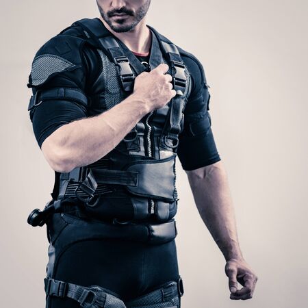 close up of young fit athletic man wearing EMS costumeの写真素材