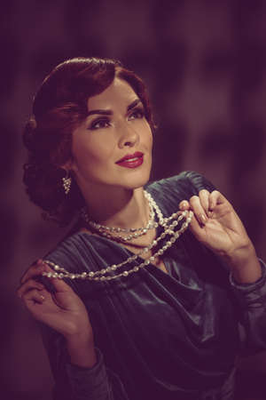 Portrait of beautiful woman dressed in vintage dress and wearing jewelryの写真素材